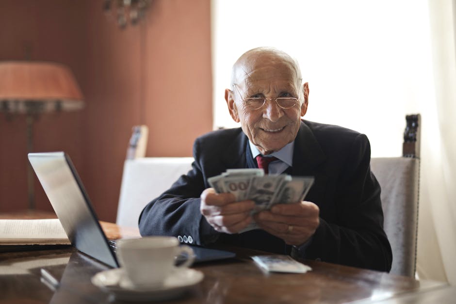 Elderly man smiling while counting cash at a home office setting